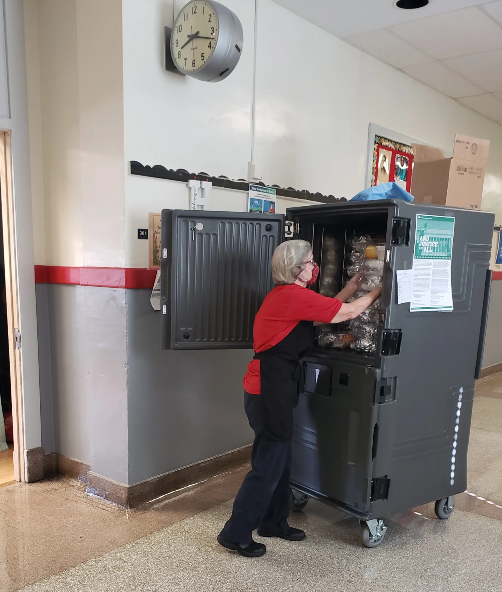 School lunch staff working with mobile cart for lunch foodservice